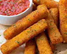 some fried food is on a plate with dipping sauce