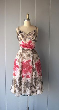 This dress is stunning. I imagine this dress being worn in Paris while roaming through the museums and gardens. It's silk chiffon with a floral painted print in pinks and brown/taupe colors. It's flowing and light and you'll feel SO pretty in this! Fitted waist line, boning on the sides o the bust (within the slip), a gorgeous sweetheart neckline with gathering chiffon just below the bust. There are double arm straps and a hidden zipper in the back. The dress also has a triple layered skirt slip Vintage Silk Dress With Floral Print, Vintage Pink Chiffon Dress, Spring Floral Print Silk Chiffon Dress, Spring Silk Chiffon Floral Print Dress, Spring Pink Silk Chiffon Dress, Pink Silk Chiffon Dress For Spring, Vintage Silk Chiffon Dress For Summer, Vintage Silk Chiffon Summer Dress, Summer Silk Chiffon Dress For Garden Party