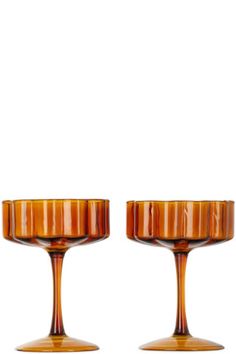 two brown glass candlesticks sitting next to each other