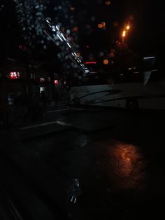 the rain is falling on the street at night