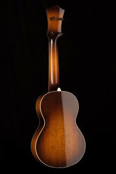 an acoustic guitar is shown against a black background