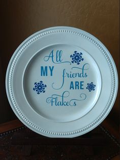 a white plate with blue lettering on it that says all my friends are flakes