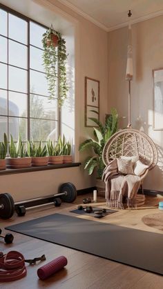 a living room with yoga mats and plants in the window sill, along with a hammock chair