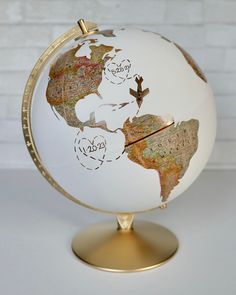 a white and gold globe with writing on it