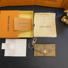 the louis vuitton wallet and keychain are on display