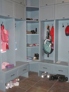 a walk in closet filled with lots of shoes and bags on shelves next to each other