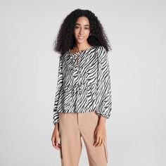 Featuring a versatile front tie that can be styled into a bow or draped for various looks, this blouse boasts mid-length puff sleeves and a flowy peplum hem for a feminine touch. The zebra and leopard print adds a trendy flair, perfectly aligning with the latest styles for a fresh look. Made from lightweight, soft fabric, it offers a relaxed fit that's ideal for pairing with jeans, skirts, or shorts. Perfect for any occasion, from casual outings to more polished events. A New Day™: Style that go Trendy Long Sleeve Tops With Tie Waist, Casual Blouse With Blouson Sleeves And Tie Neck, Fall Long Sleeve Blouse With Tie Waist, Casual Blouse With Puff Tie Sleeves, Chic Long Sleeve Top With Tie Waist, Casual Tops With Blouson Sleeves And Tie Neck, Trendy Tie Neck Blouse For Day Out, Fall Tie-neck Blouse For Day Out, Fall Tie Neck Blouse For Day Out