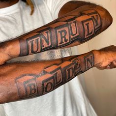 two men with tattoos on their arms that read unrulty and golden in large letters