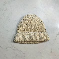 a knitted hat sitting on top of a white counter