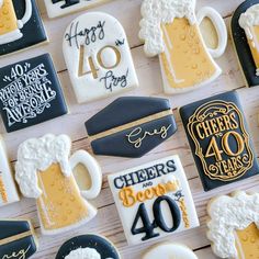 decorated cookies are arranged on a table with beer mugs and cheers 40 years written on them