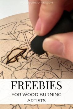 a person drawing on a piece of wood with the words freebies for wood burning artists