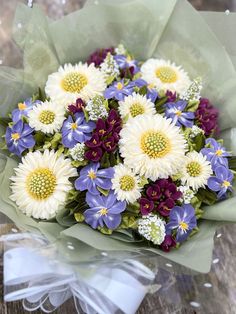 a bouquet of flowers sitting on top of a wooden table