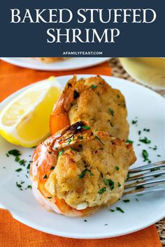 baked stuffed shrimp on a plate with lemon wedges