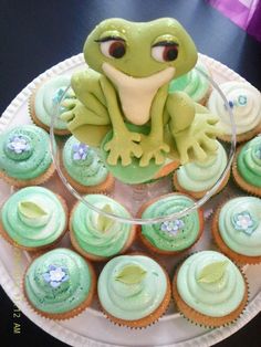 cupcakes with green frosting and an image of a frog sitting on top