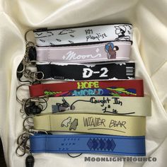 four lanyards are stacked on top of each other in different colors and designs