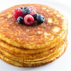 stack of pancakes with berries and blueberries on top