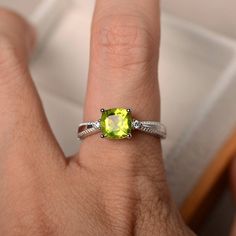 This ring features a 7*7 mm cushion cut natural peridot and sterling silver finished with rhodium. Customization is available. It is made by hand, and it will take about 7 days to finish the ring after your payment is completed. Main stone: natural peridot Main stone weight: Approx 1.56 ct Metal type: sterling silver finished with rhodium Accent stone: cz Customization is available, I also can make it with 14k solid gold (white or yellow or rose) and diamond accent stone, just feel free to conta Three Stone Engagement Rings Cushion, Peridot Wedding Ring, Engagement Ring Cushion Cut, Engagement Ring Three Stone, Engagement Ring Cushion, Birthstone Engagement Rings, Original Engagement Rings, August Birthstone Ring, Ring Three Stone