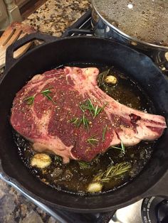 a piece of meat is cooking in a skillet