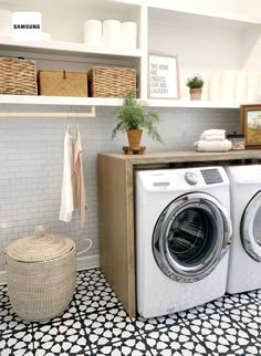 a washer and dryer in a room with black and white tile flooring