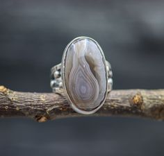 ♦Special Features: This ring features my not so wide bubble band and a beautiful Botswana agate. The band is full of texture and my granulation and a nice soft patina highlighting the textures. The stone is really something else. I admit to having a weakness for banded agates and this one has the most beautiful translucency to the banding. You can see how ribbon like each layer is and sort of watch it go down into the stone. These are a delight to examine and the coloring is a perfectly neutral Artisan Rings With Agate And Natural Stones, Artisan Agate Rings With Natural Stones, Botswana Agate, Shades Of Beige, Banded Agate, Size 10 Rings, Something Else, Botswana, Band Ring