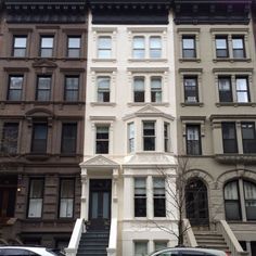 two cars are parked in front of some buildings