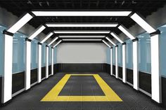 an empty hallway with yellow and black lines on the floor is shown in this image