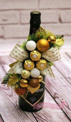 a bottle filled with gold and white ornaments