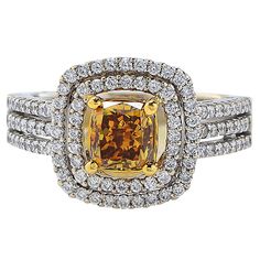 Stunning engagement ring crafted in 18 Karat Yellow and White Gold, showcasing a GIA Certified Fancy Deep Brownish Yellow radiant cut diamond weighing 1.23 carats adorned by 102 round brilliant cut diamonds weighing approximately .59 carats total, G color, VS clarity. Our pieces are all accompanied by an appraisal performed by one of our in-house GIA Graduates. They are also accompanied by GIA grading report(s), AGL grading report(s), original certificate(s) and other documents, if specified in Color Diamond Ring, Fancy Color Diamond Ring, Yellow Diamonds Engagement, Yellow Diamond Engagement Ring, Brownish Yellow, Colored Diamond Rings, Fancy Yellow Diamond, Stunning Engagement Ring, Radiant Cut Diamond