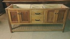 a wooden cabinet with two drawers and three doors