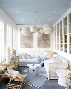 a living room filled with lots of white furniture