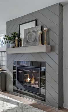 a living room with a fireplace and pictures on the mantle