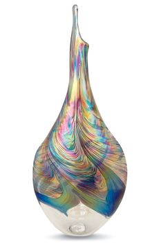 a multicolored glass vase sitting on top of a white table