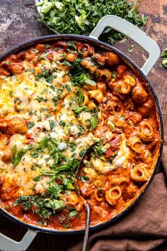 a skillet filled with pasta and sauce