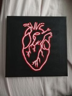 a heart painted on a black canvas with red light coming from the center and bottom