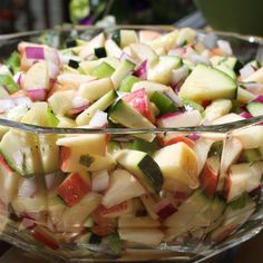 a bowl filled with sliced up vegetables on top of a table