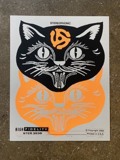 an orange and black sticker with a cat's face on it is shown