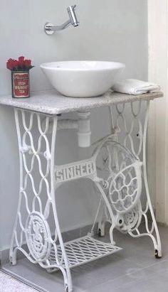 a white bathroom sink sitting under a faucet