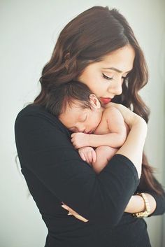 a woman holding a baby in her arms