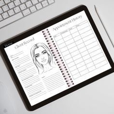 a clipboard with a woman's face on it next to a computer keyboard