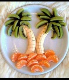 a white plate topped with sliced oranges and banana's on top of each other