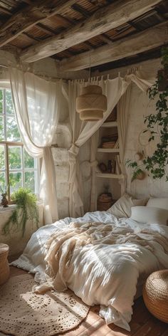 an unmade bed with white sheets and pillows in a room next to a window