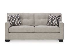 a gray couch with two pillows on it