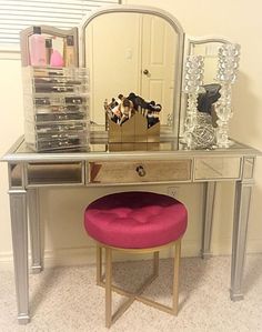 a vanity table with a mirror and stool