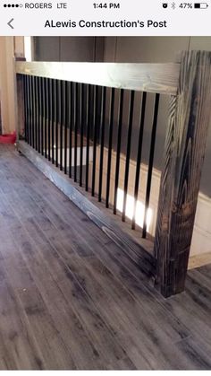 an empty room with wood flooring and railings on the bottom half of it