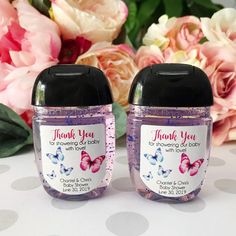 two small jars with pink and blue butterflies on them