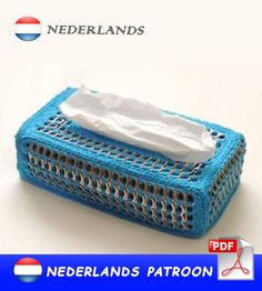 a blue crocheted tissue box with white tissue in it and the words nederland's patron