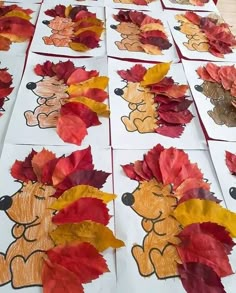 the paper leaves have been made to look like hedgehogs with red and yellow leaves on them