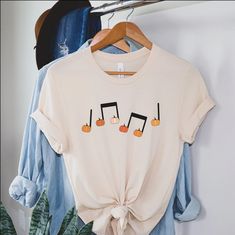 Pumpkin Music Note T-shirt Fall Music Teacher Tee Halloween - Etsy Fall Music-themed Graphic Print T-shirt, Fall Music-themed Cotton Tops, White T-shirt For Fall Concert, White T-shirt For Concerts In Fall, Boy Mom Shirt, Mom Graphic Tees, Halloween Tee Shirts, Mom Of Boys Shirt, Auntie Shirts