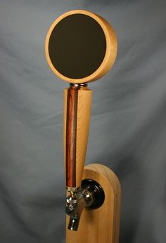 a wooden stand with a mirror on it and a faucet attached to it