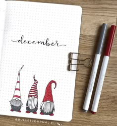 an open planner with three gnomes and the word december written in black on it